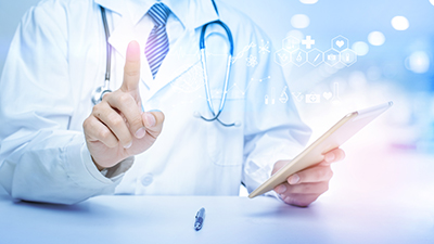 Male doctor holding lab results, holding up a finger pointing upwards