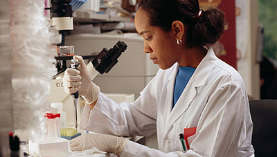 Woman researcher using a pipette