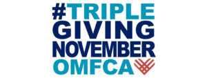 TGN logo: #TRIPLEGIVINGNOVEMBEROMF. The phrase is written in bold, uppercase letters with a mix of dark blue and light blue colors. The "OMF" text is in light blue, and there is a stylized heart shape in reddish-orange next to it.