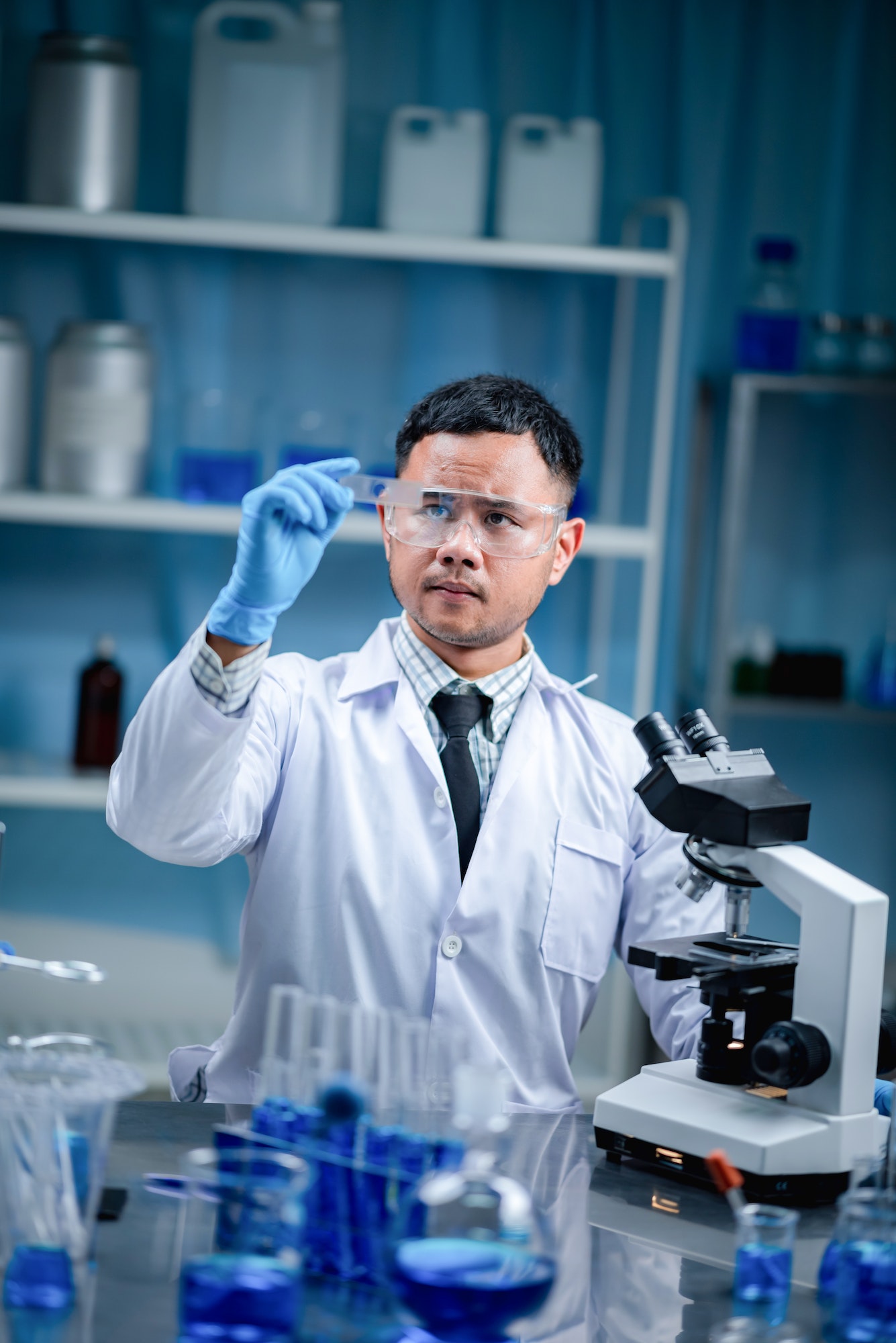 Man researcher looking at a slide