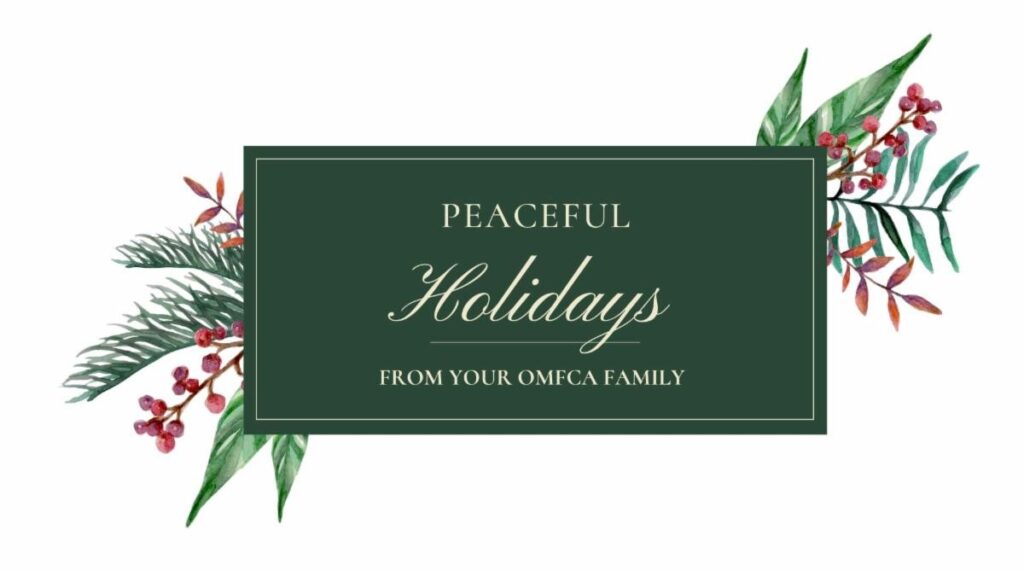 The image features a holiday greeting card with a dark green background. In the center, it reads "Peaceful Holidays from your OMFCA Family!" in elegant, light-colored script. Surrounding the text are watercolor illustrations of festive greenery and berries on both sides.